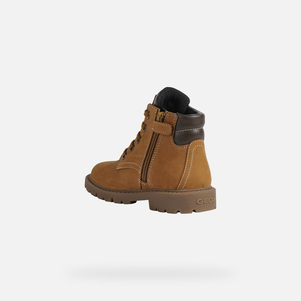 A boys lace up ankle boot by Geox, style Shaylax Boy, in yellow/brown. Angled back view