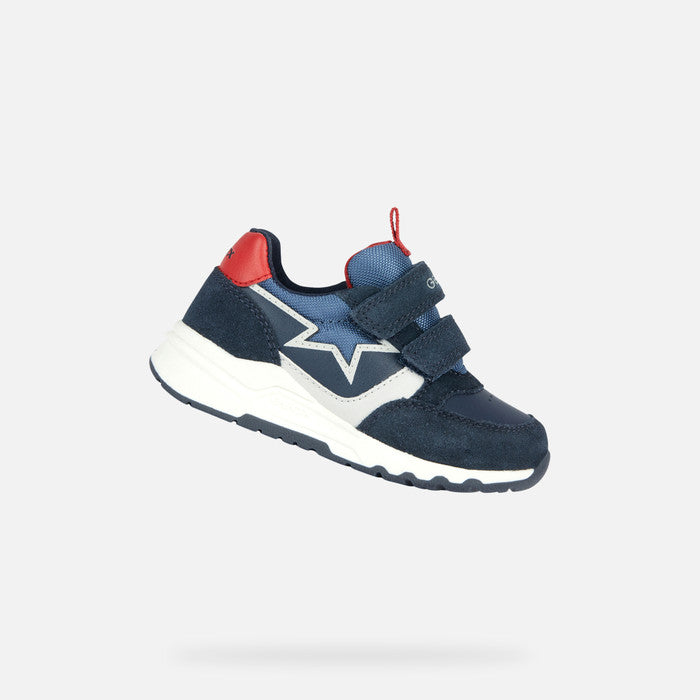A casual sports trainer by Geox, style B Pyrip Boy, in navy suede/ other material with red heel and tab and light grey star outline on the side. Double velcro fastening. Angled view.