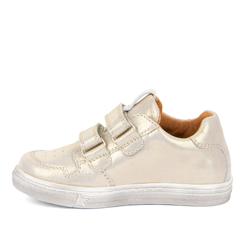 A girls casual occasion shoe by Froddo, style G2130315-11 Dolby, in light gold metallic with gold sequin block and star detail, double velcro fastening. Left side view.