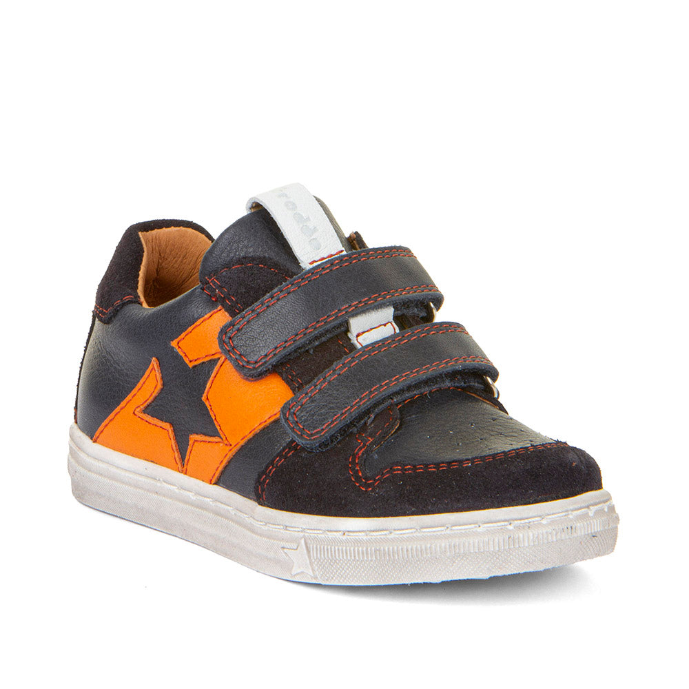 A boys casual shoe by Froddo, style G2130315 Dolby, in navy with orange block and star detail, double velcro fastening. Angle view.
