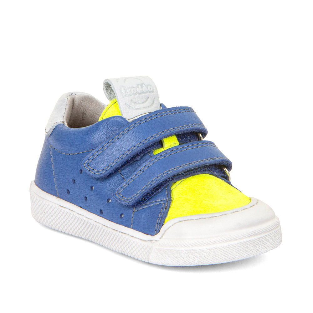 A boys casual shoe by Froddo, style Rosario G2130316-26, in blue and yellow leather with white trim and toe bumper. Velcro fastening. Angled view.