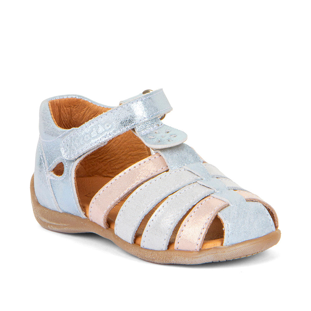 A girls leather sandal by Froddo, style Carte Girly, in blue and pink metallic leather with single velcro fastening. Angle view.