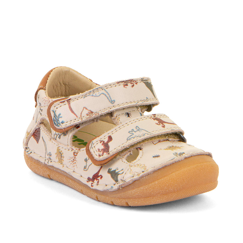 A unisex sandal by Froddo, style Paix-Up Double in beige with two velcro straps, toe bumper and dinosaur pattern. Angled front view