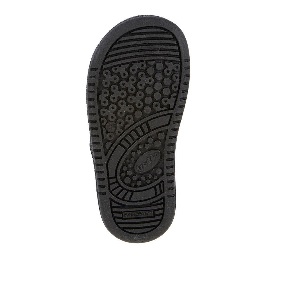 A girls barefoot school shoe by Froddo. In a loop Sandra style, black patent, with a tbar velcro strap and love heart design on the front. Sole view.