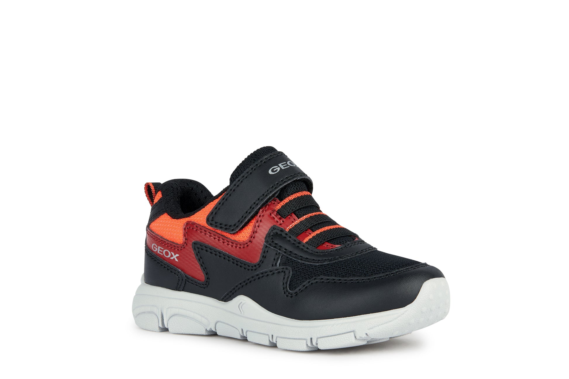 A boys trainer by Geox, style New Torque, in black, red and orange with a velcro strap and bungee laces. Angled view.