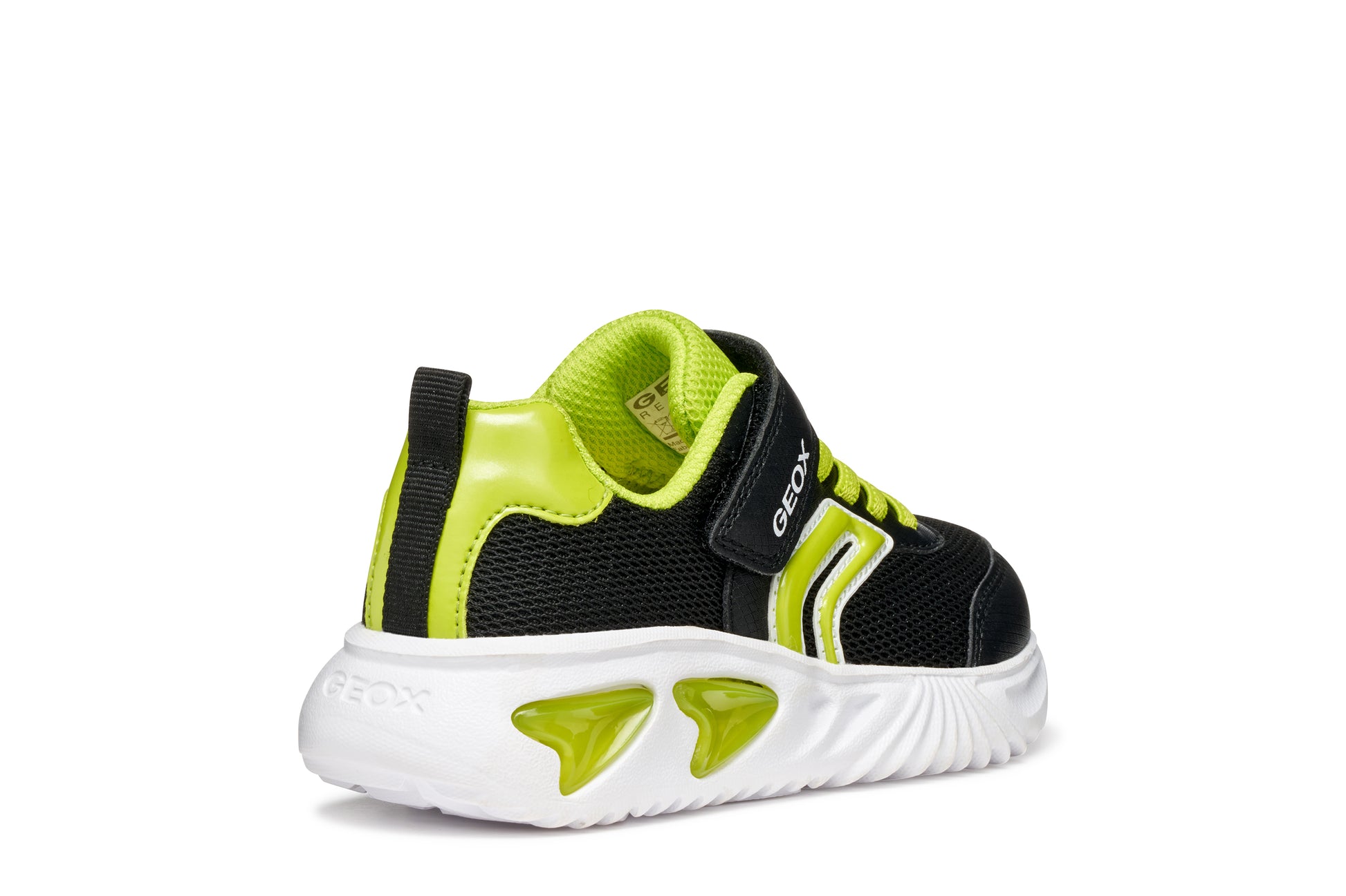A boys trainer by Geox, style Assister, in black/lime with velcro strap and green laces. Angled right side view.