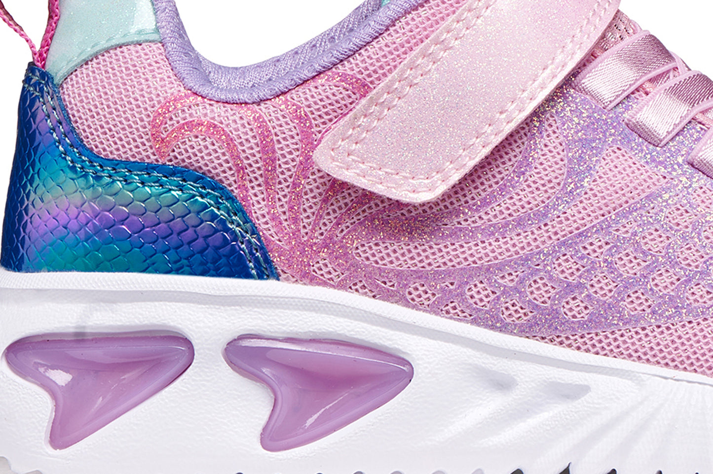 A girls trainer by Geox, style Assister in pink/lilac with one velcro strap and elastic laces, mermaid detail on heel and lights in sole. Zoomed image of right side
