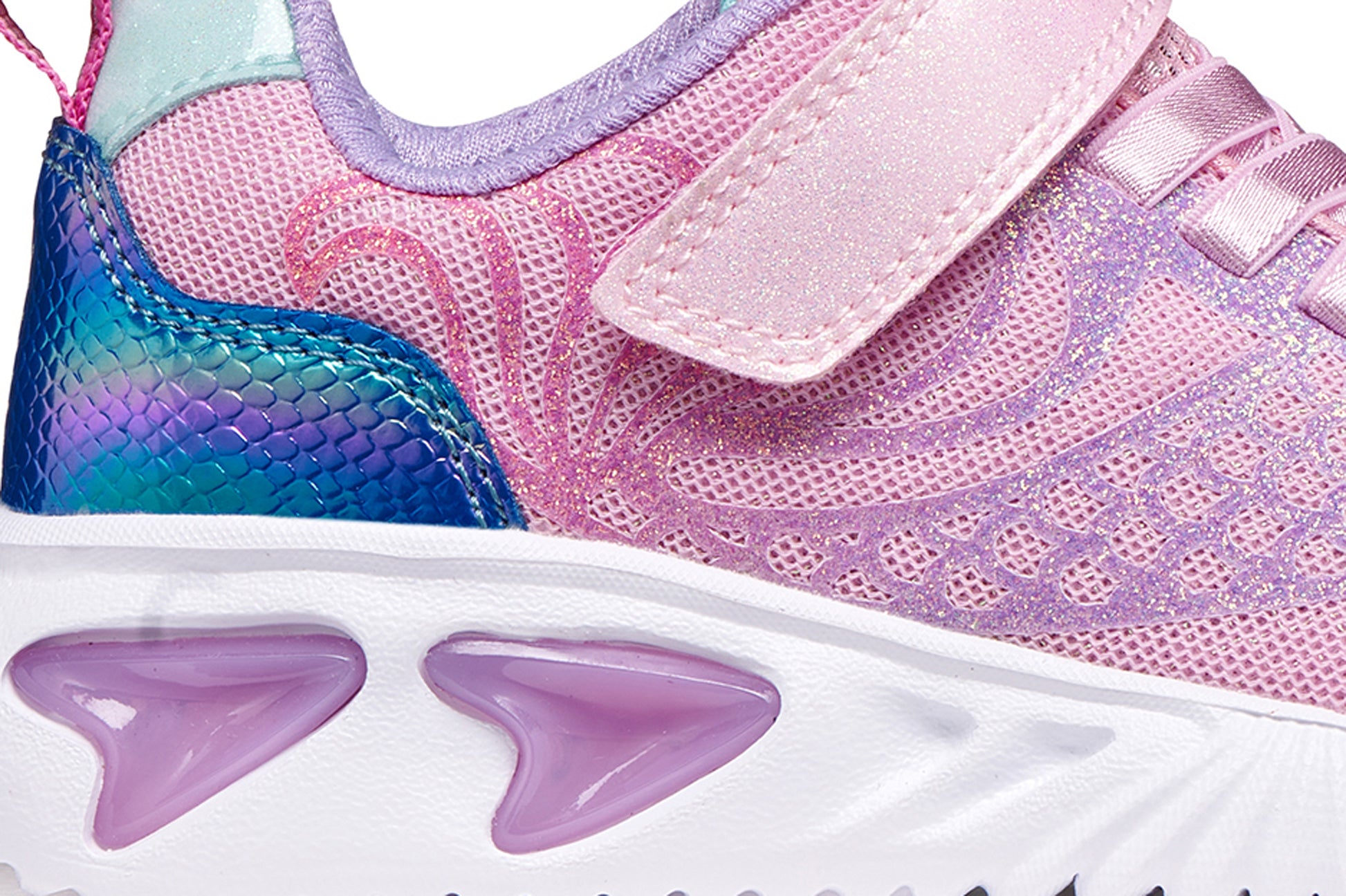 A girls trainer by Geox, style Assister in pink/lilac with one velcro strap and elastic laces, mermaid detail on heel and lights in sole. Zoomed image of right side