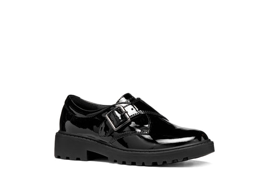 A girls' school shoe by Geox, style J Casey Girl in black patent with velcro strap with buckle and chunky sole. Angled right side view