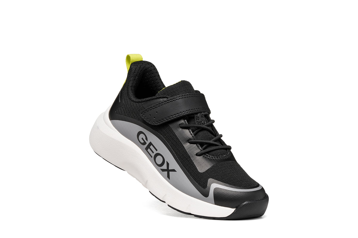 Geox boys trainer in the style Pro-Ran in black, white and grey with a Velcro strap, GEOX logo and white sole. Right side view.