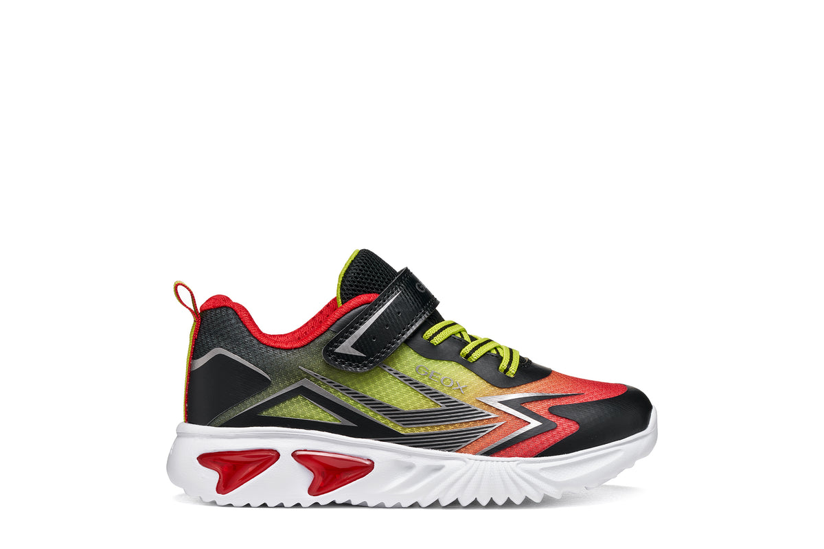 Geox boy's trainer in the style Assister, in red, yellow and black with a Velcro strap, lights and a white sole. Right side view.