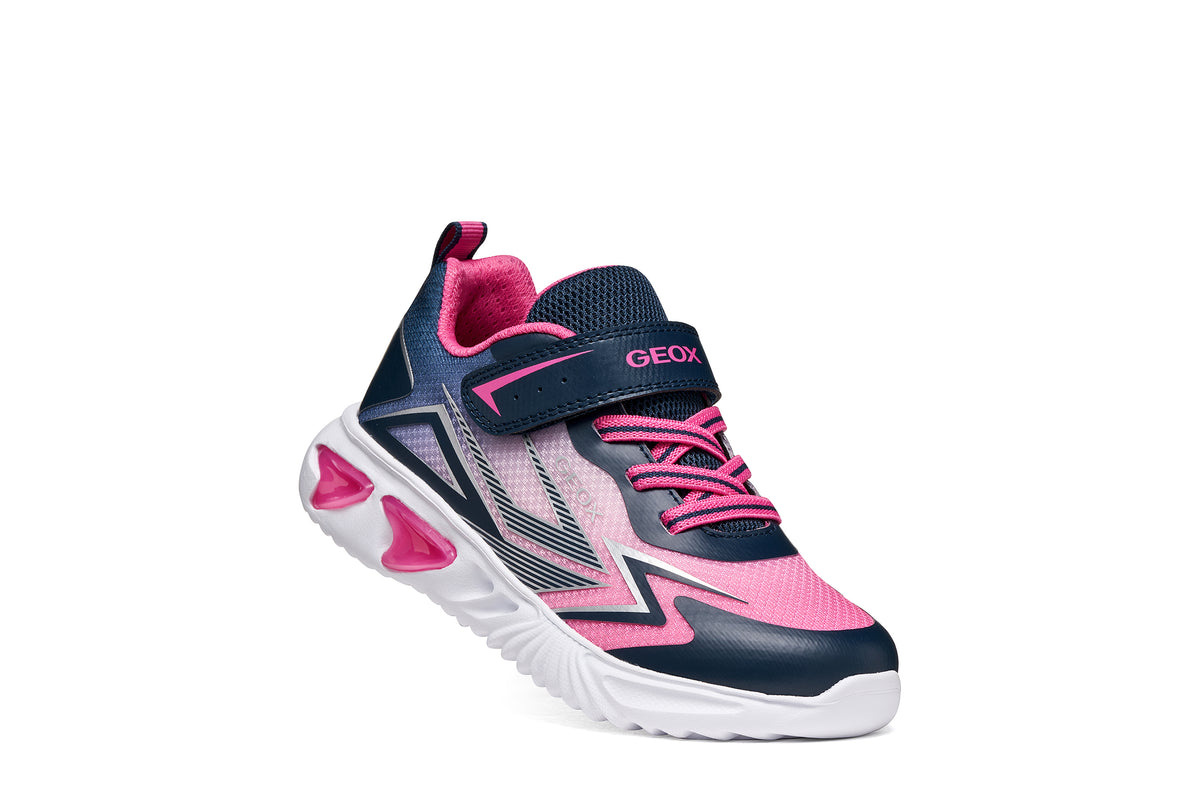 Geox girls trainer in the style Assister in navy, pink and white with a Velcro strap, lights and a white sole. Right side view.