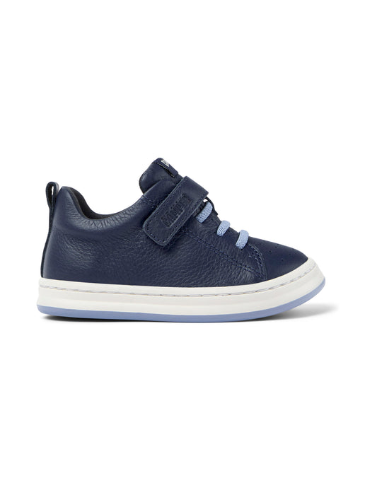A boys shoe by Camper, style Runner FW, in navy with velcro strap and light blue elastic laces. Right side view.