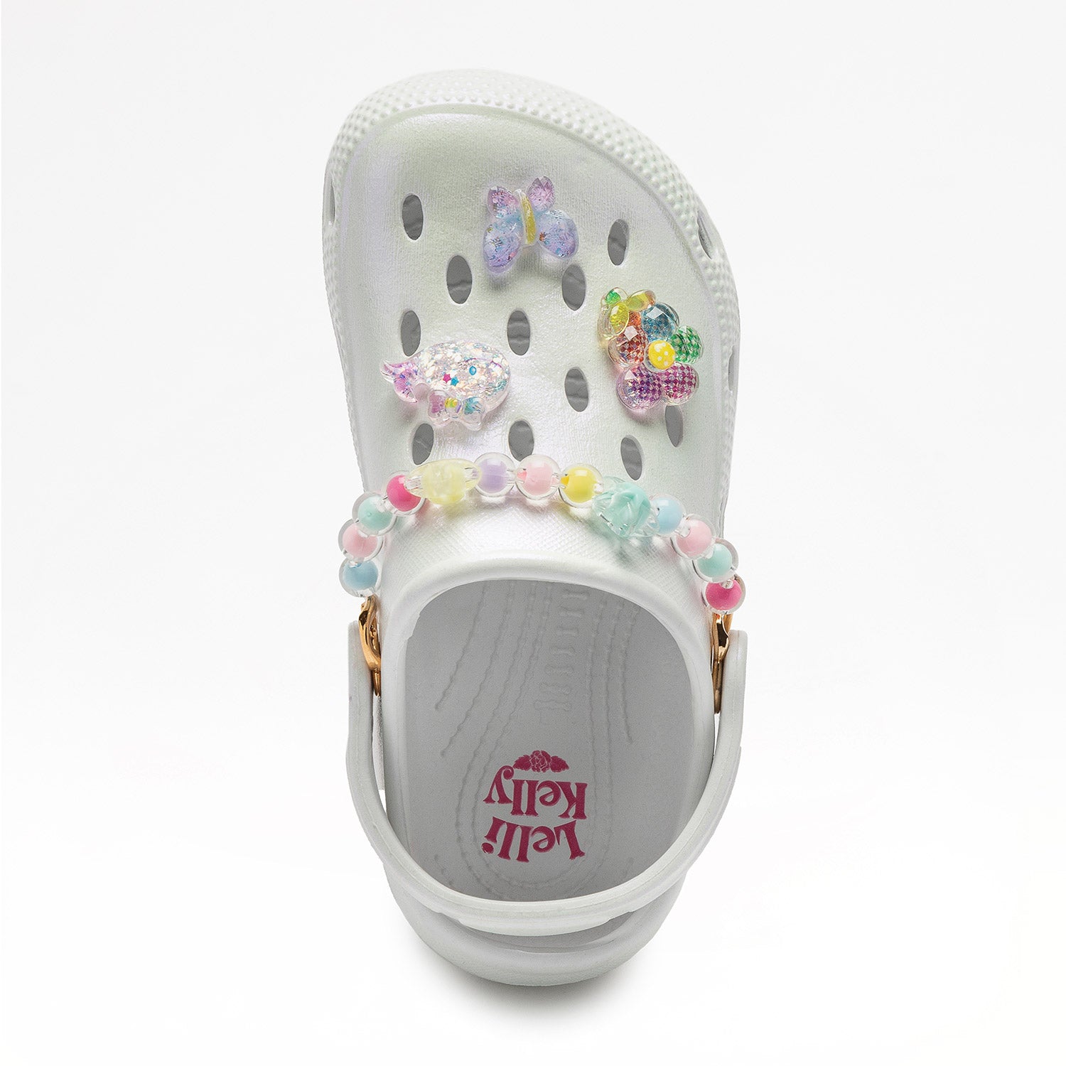 A girls clog style sandal by Lelli Kelly, style Melody in white with colourful pastel beads and charms on front. Top view 