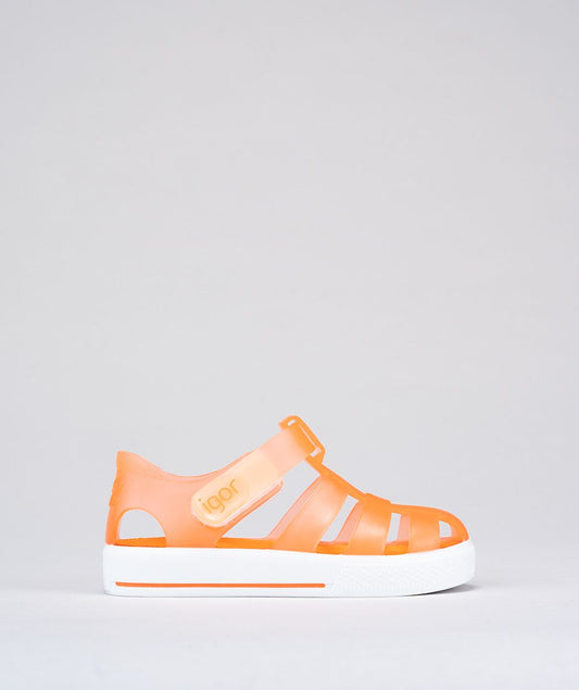 A unisex Jelly shoe by Igor, style Star in orange with a white sole, velcro fastening. Right side view.
