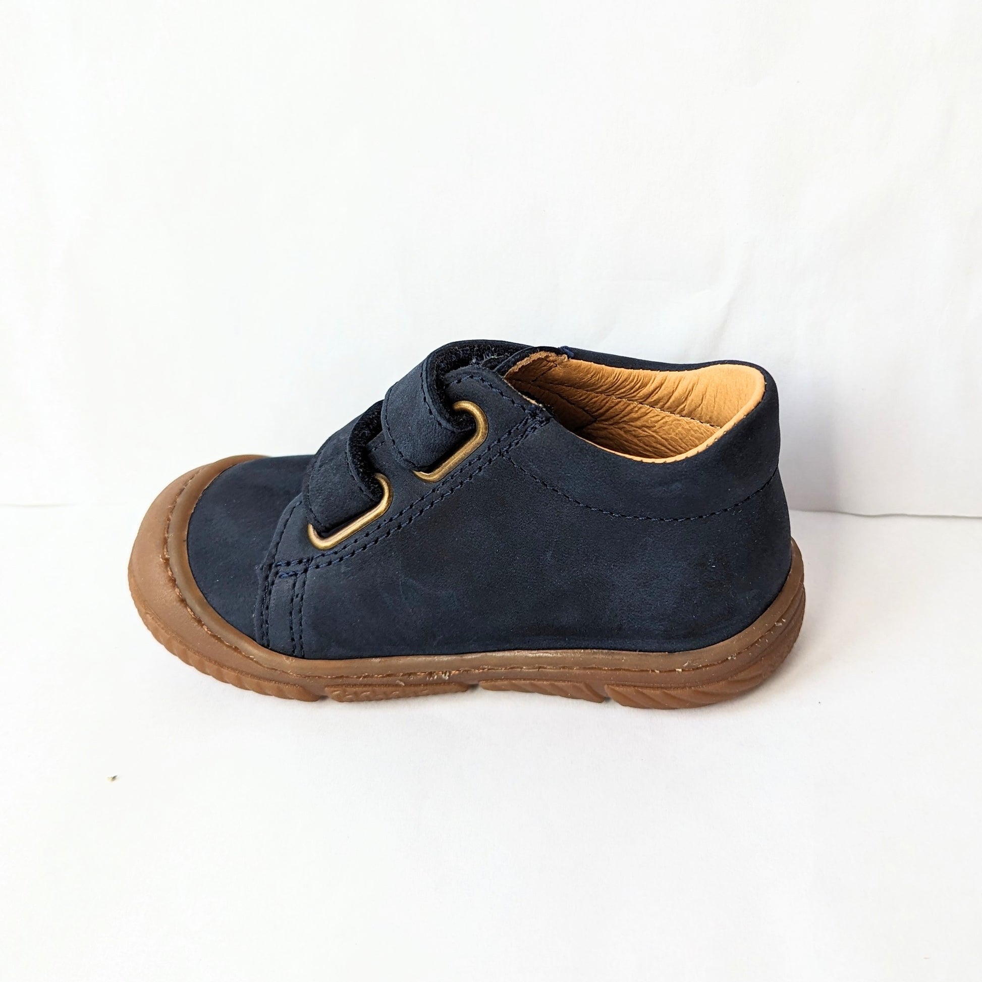 A boys ankle boot by Bopy, style Jameco, in navy nubuck with toe bumper and double velcro fastening. Left side view.