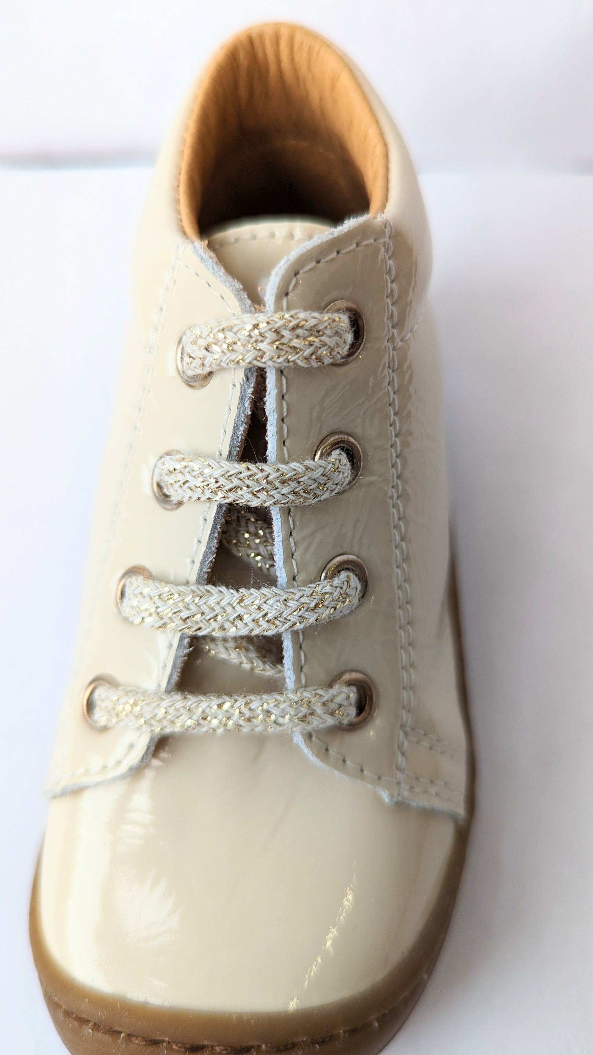 A girls ankle boot by Bopy, style Jordana, in cream crinkled patent with toe bumper and lace up fastening. Close up view.