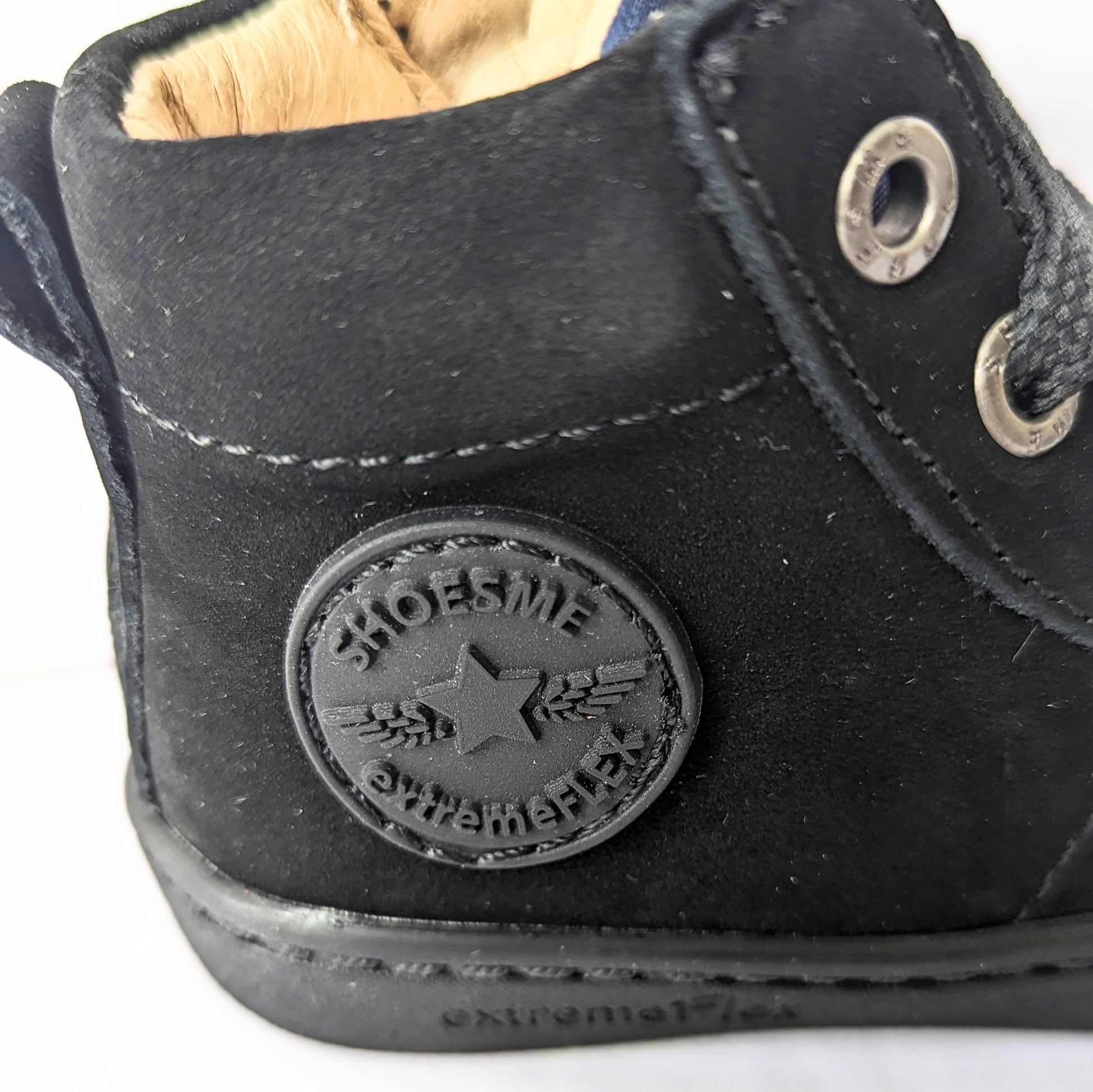 A unisex hi-top boot by Shoesme, style FL23W002-A in black leather nubuck with lace and zip fastening. Close up of shoesme motif.