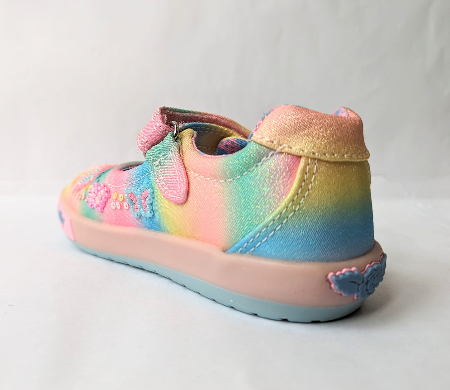 A girls Mary Jane shoe by Lelli Kelly, style LKED3463 Myla, in multi coloured canvas with sequin and bead embellishments and velcro fastening. Angled view of left side.