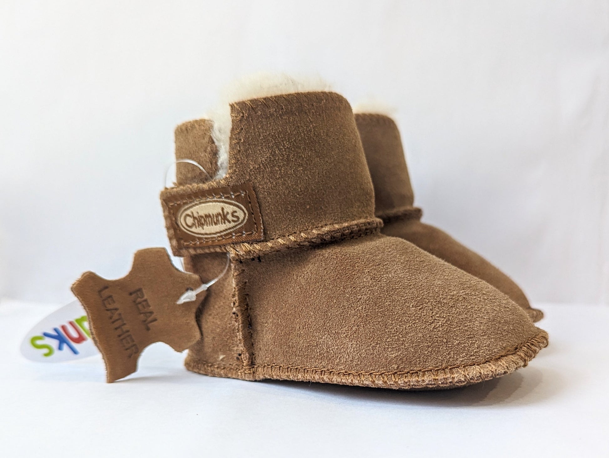 A pair of unisex pull on warm lined slipper boots by Chipmunks, style JoJo, in tan. Right angled view.
