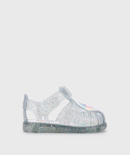 A girls jelly sandal by Igor, style Unicornio in transparent/multi/glitter with velcro strap and unicorn design on front. Right side view