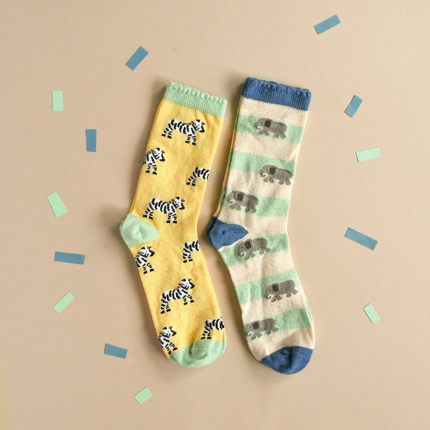 Two pairs of socks with animal patterns by Rockahula on a beige background