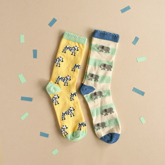 Two pairs of socks with animal patterns by Rockahula on a beige background
