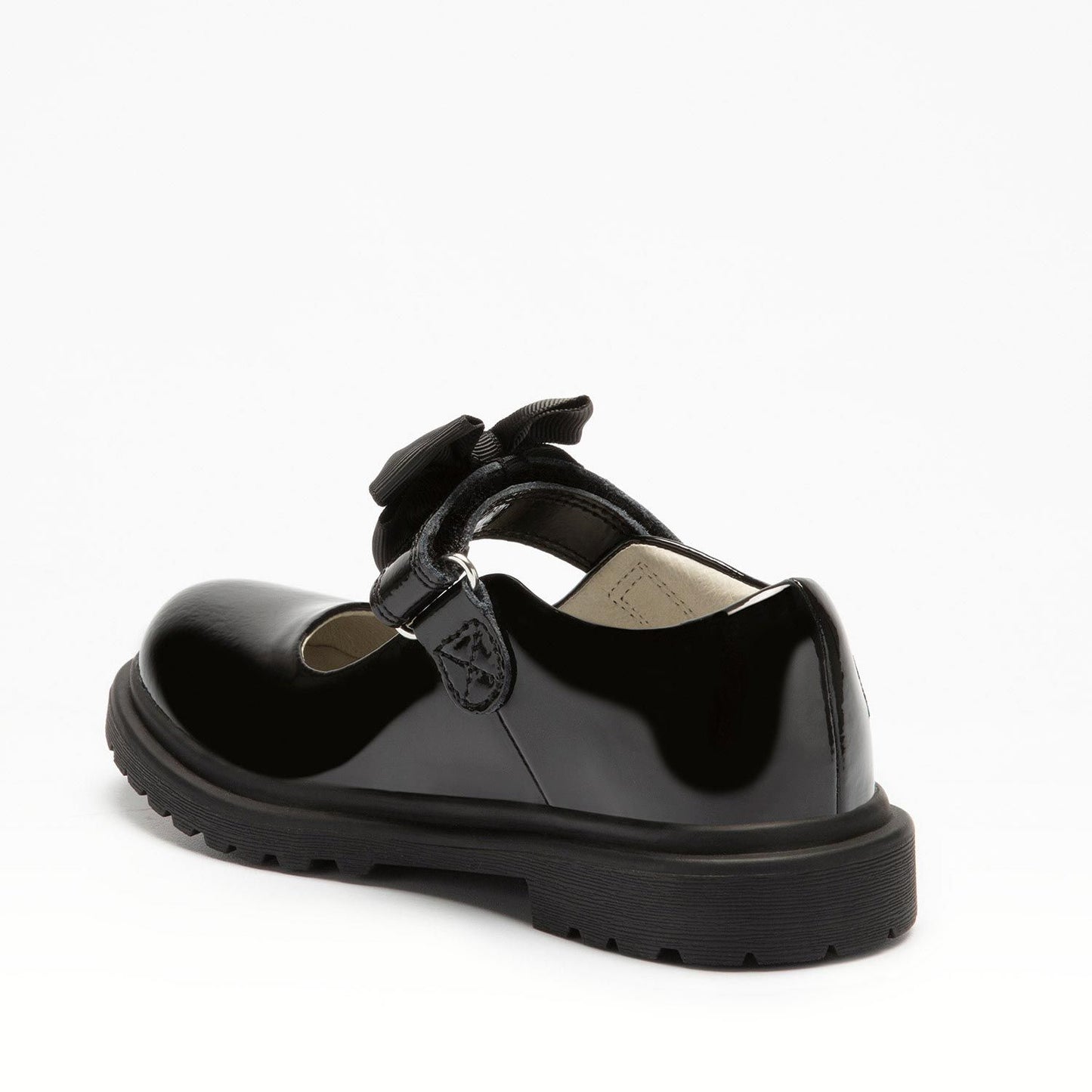 A girls chunky Mary Jane school shoe by Lelli Kelly, style LK8661 Maisie, in black patent leather with velcro fastening and detachable black fabric bow. Angled view.
