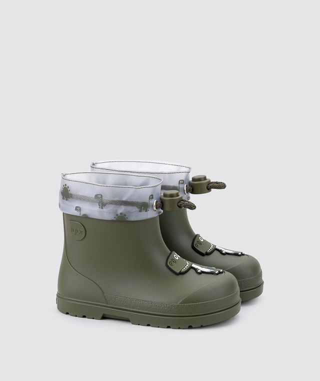 A pair of unisex wellies by Igor, style W10323-042 Mendi Dino, in Khaki with dino detail and toggle fastening. Angled right sided view of a pair.