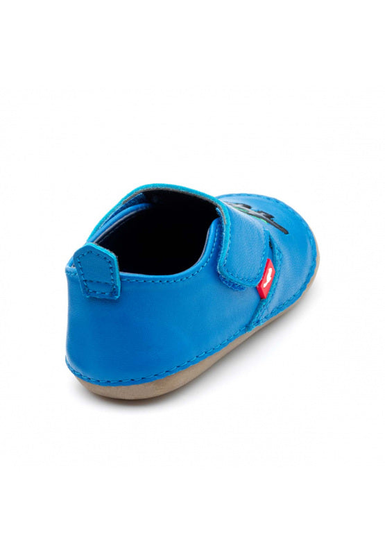 A unisex pre walker by Chipmunks, style Dara Dino, in blue with dinosaur design and velcro fastening. Angled view from back.