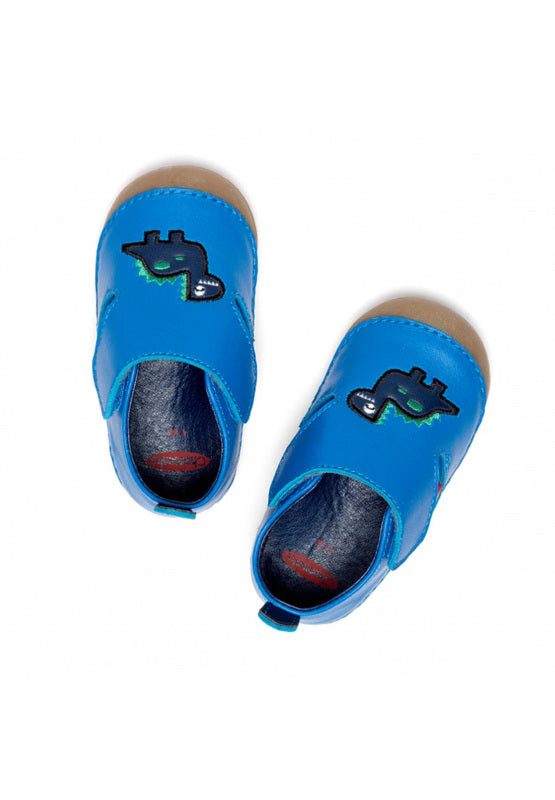 A pair of unisex pre walkers by Chipmunks, style Dara Dino, in blue with dinosaur design and velcro fastening. View from above.