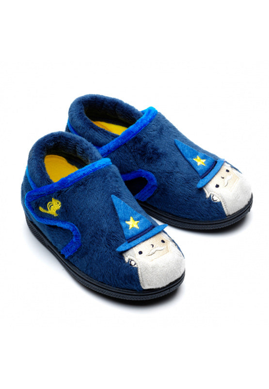 A pair of unisex slippers by Chipmunks, style Abracadabra Wizard, in navy multi wizard design with velcro fastening. Angled view from right side.