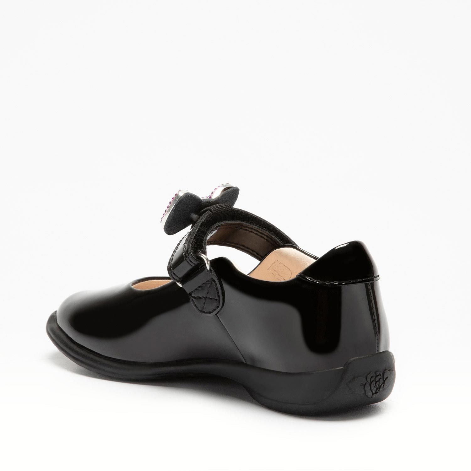 A girls Mary Jane school shoe by Lelli Kelly, style LK8116 Erin, in black patent leather with velcro fastening and detachable multicoloured bow. Angled view.