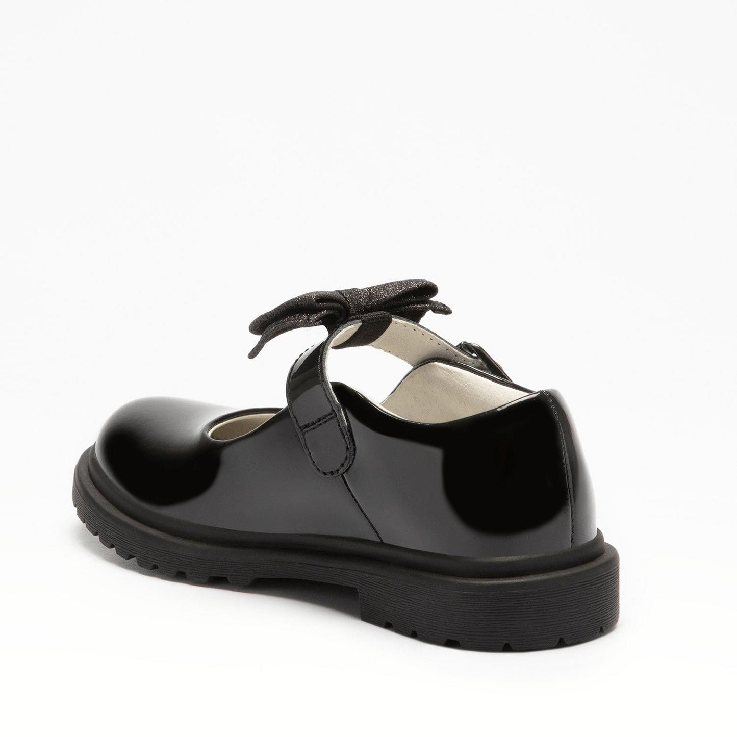A girls chunky Mary Jane school shoe by Lelli Kelly, style LK8359 Mollie, in black patent leather with buckle fastening and detachable fabric bow. Angled view.