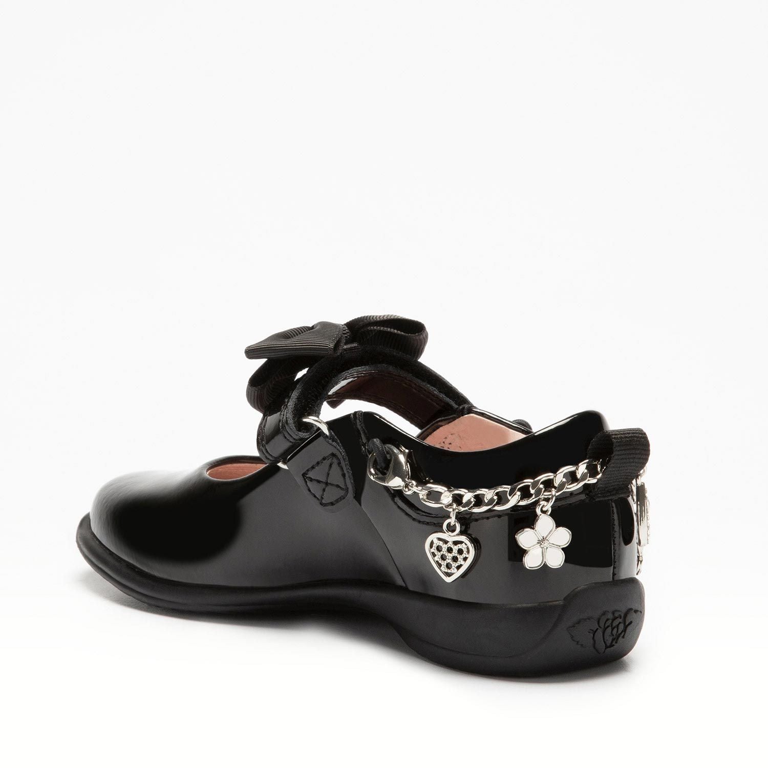 A girls Mary Jane school shoe by Lelli Kelly, style LK8219 Alicia, in black patent leather with velcro fastening and detachable fabric bow and bracelet. Angled view.