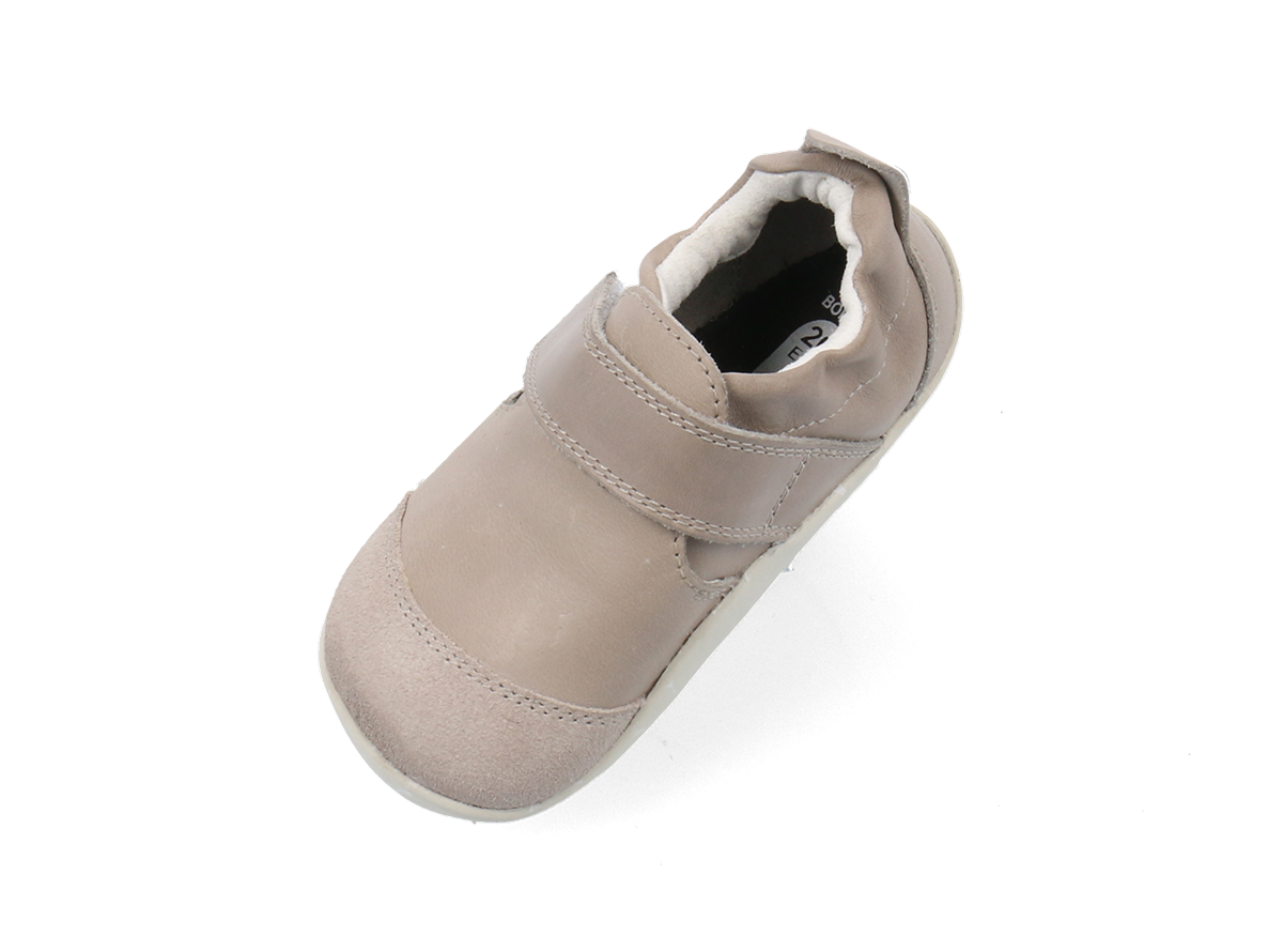 A unisex pre-walker by Bobux, style XP Marvel ,in  taupe leather and suede with velcro strap.  Angled view from above.