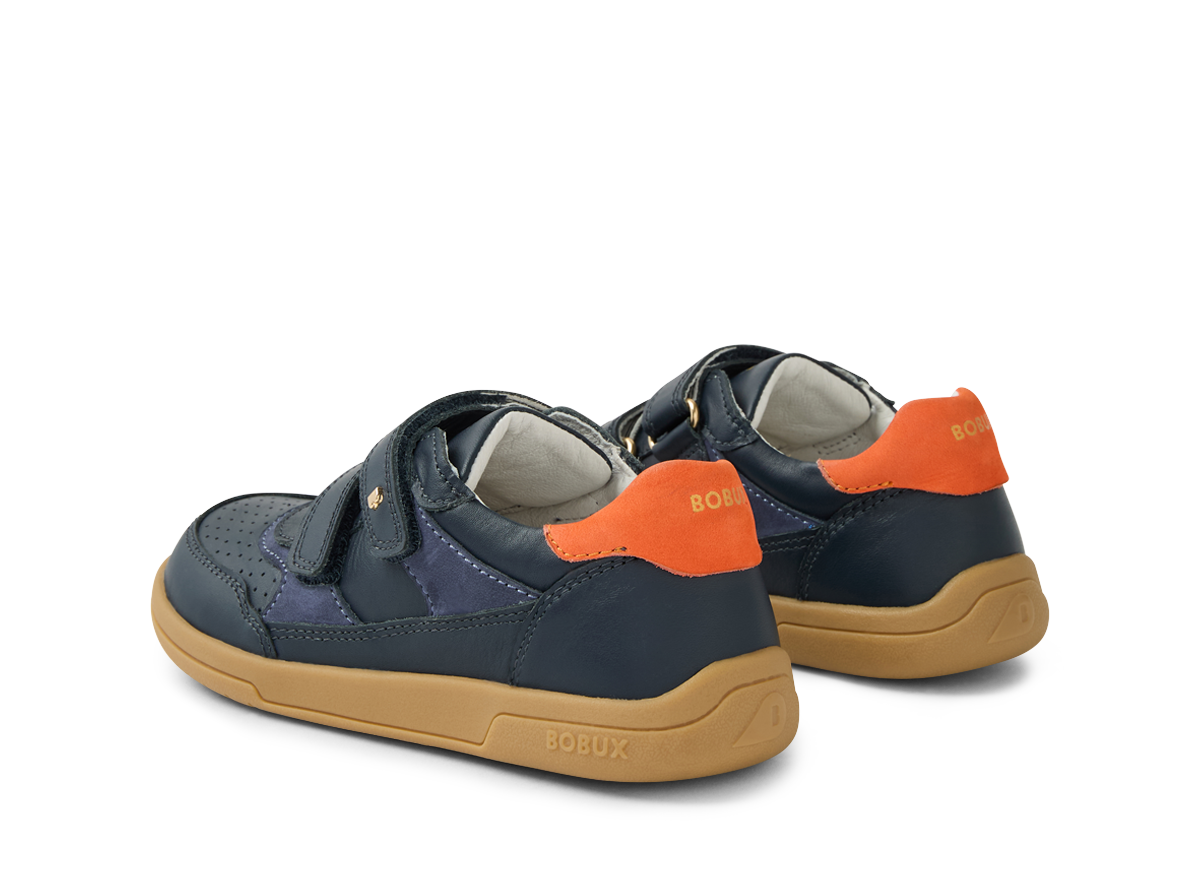 A pair of boys casual shoes by Bobux ,style Hunter, in blue and orange with double velcro fastening. Angled left side view of pair.