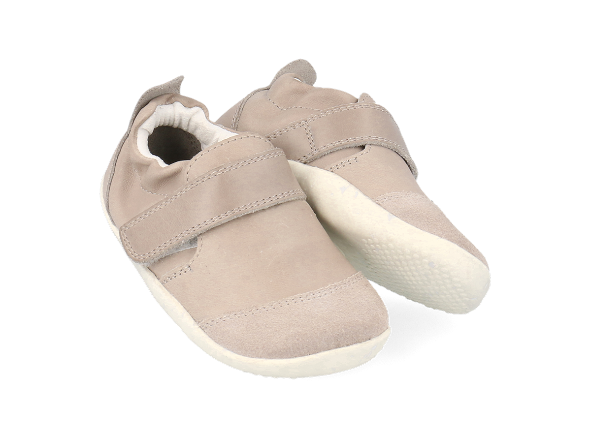 A unisex pre-walker by Bobux, style XP Marvel,in  taupe leather and suede with velcro strap. Angled view of a pair.