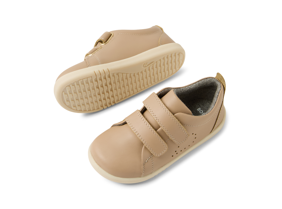 A pair of  unisex casual shoes by Bobux, style Grass Court, in taupe leather with double velcro fastening. angled view of a pair.