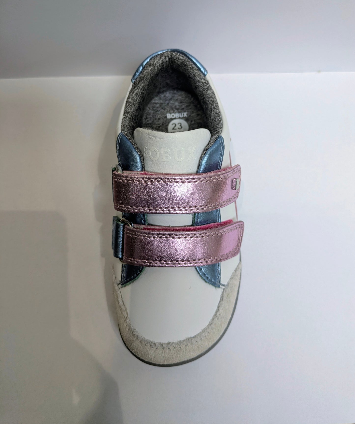 A girls casual shoe by Bobux , style I - Walk Blaze, in white with pink and blue metallic accents and grey sole. Double velcro fastening. Above view.