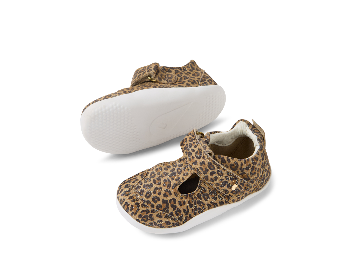 A girls T-Bar pre walker by Bobux, style XP Scout, in brown leopard print with velcro fastening. Angled view of a pair showingsole and top of shoe.