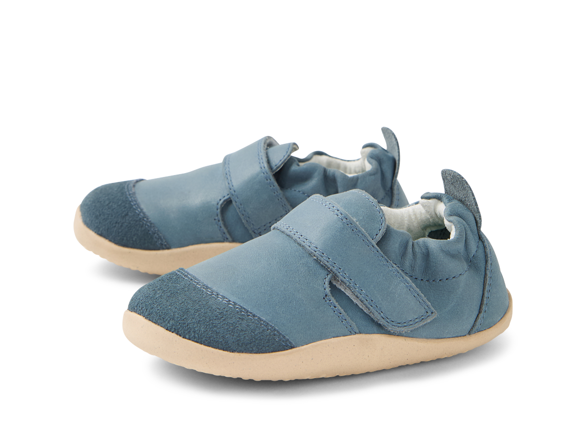 A pair of unisex pre walkers by Bobux ,style Marvel XP, n blue with velcro fastening. Left side view.