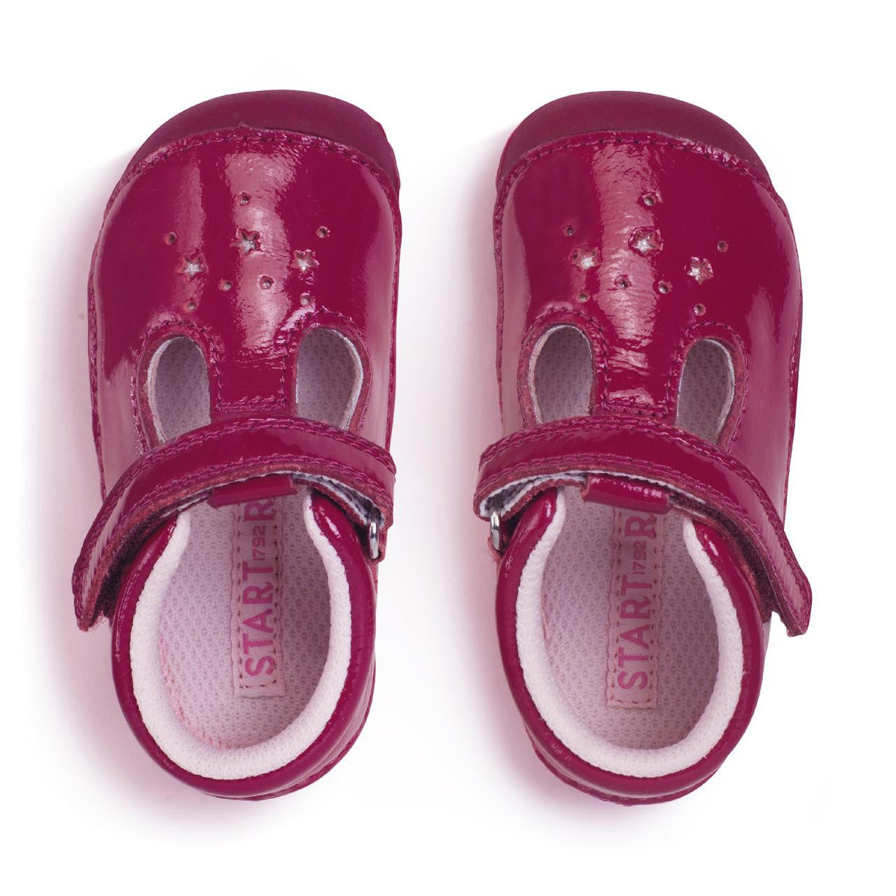 A girls T-bar pre walker by Start-Rite, Style Tumble, with star design and toe bumper, in red with velcro fastening. Above view of pair.