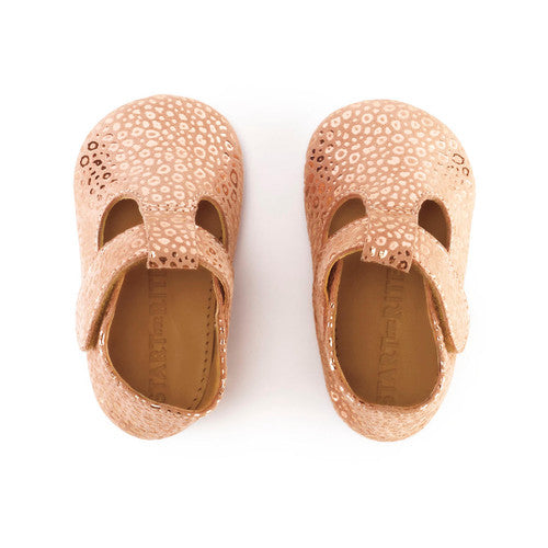 A pair of girls t-bar pram shoe by Start Rite, style Rhyme,in nude suede and gold with velcro fastening. Above view.