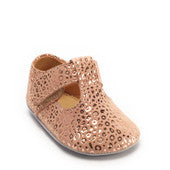 A girls t-bar pram shoe by Start Rite, style Rhyme,in nude suede and gold with velcro fastening. Angled view.