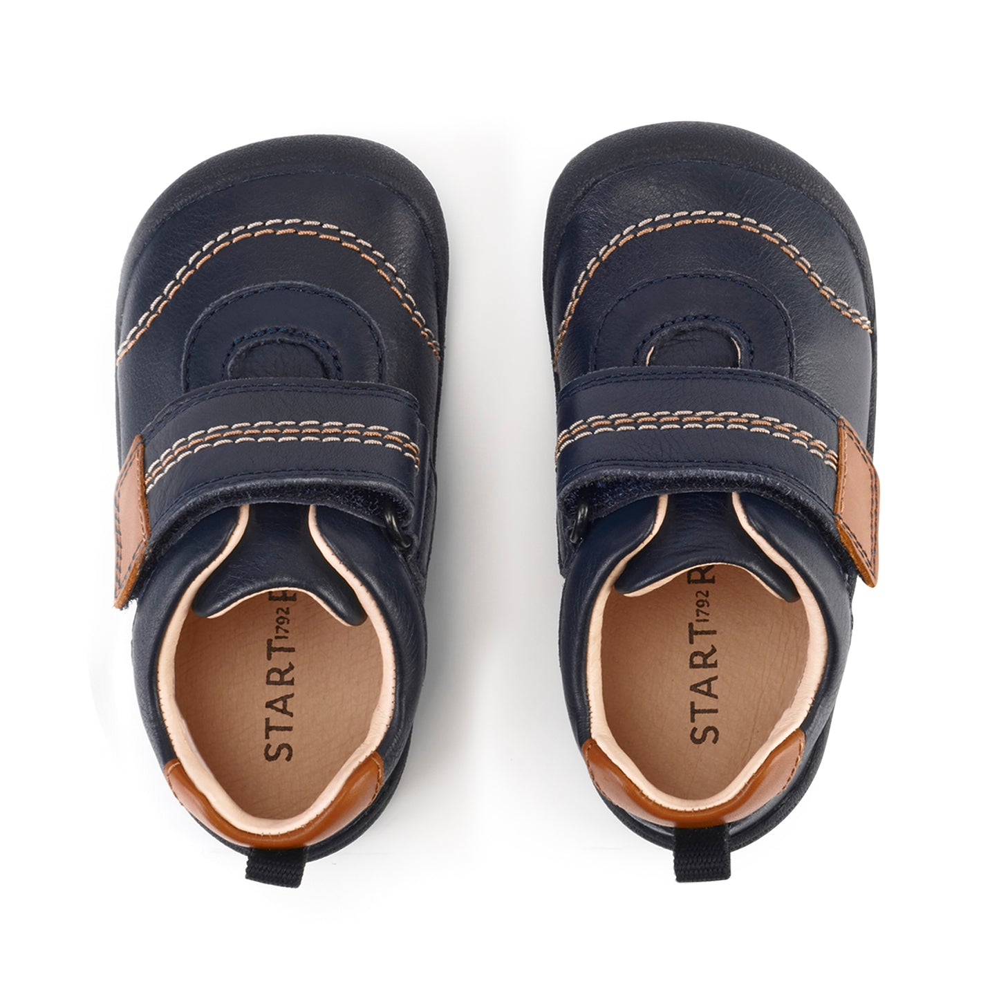 A boys first shoe by Start-Rite, style Footprint, in navy with tan trim and stitch detailing, velcro fastening. Above view of a pair.