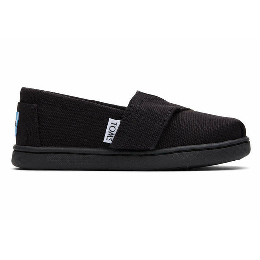 A unisex canvas shoe by Toms, style Alpargata, in Black with velcro fastening. Right side view.