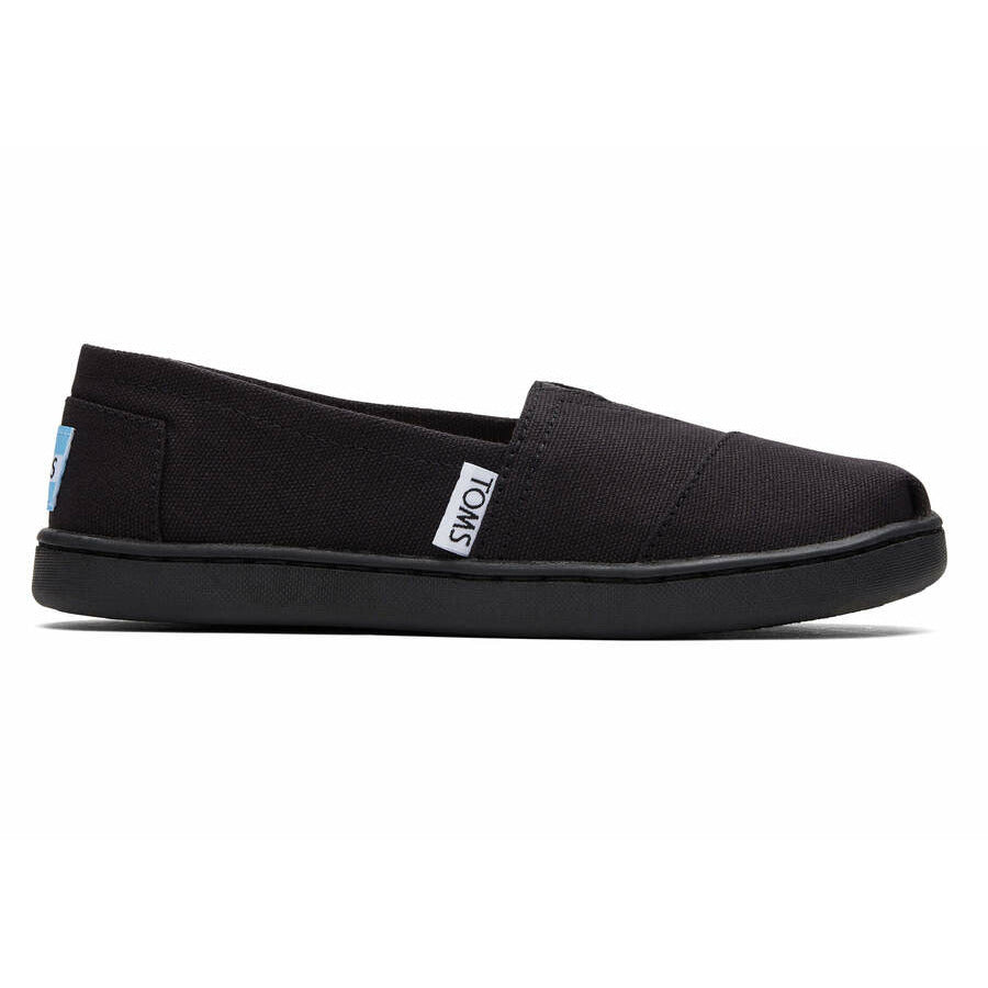 A unisex canvas shoe by TOMS, style Alpargata, a slip on  in black. Right side view.