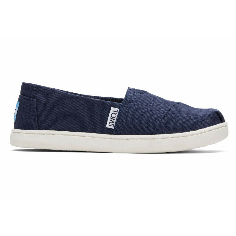 A unisex canvas shoe by TOMS, style Alpargata, a slip on in navy. Right side view
