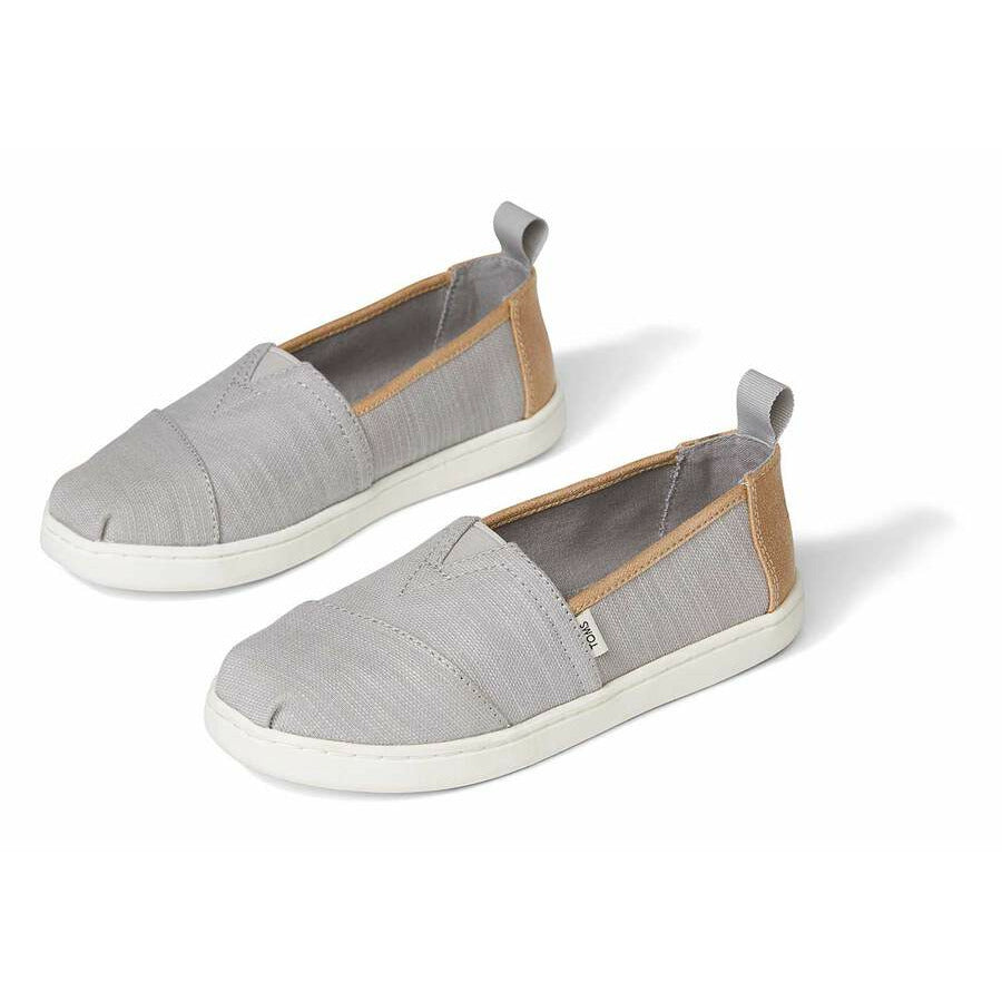 A unisex canvas shoe by TOMS, style Alpargata, a slip on in Grey and Tan. Front and side view of a pair.